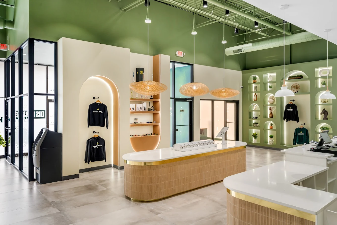 Interior of a cannabis dispensary with white and wood accents and green walls
