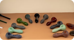 Various colored glass pipes on a brown surface