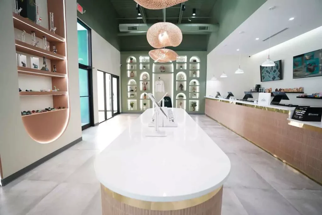 Modern interior of a cannabis dispensary with white counter and display shelves
