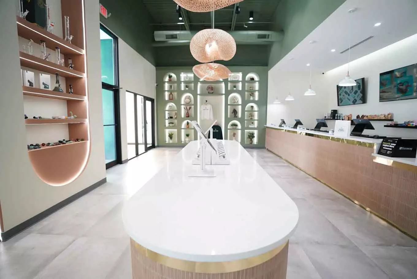 Modern interior of a cannabis dispensary with white counter and display shelves